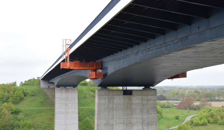A concrete bridge with a maintenance platform installed below.