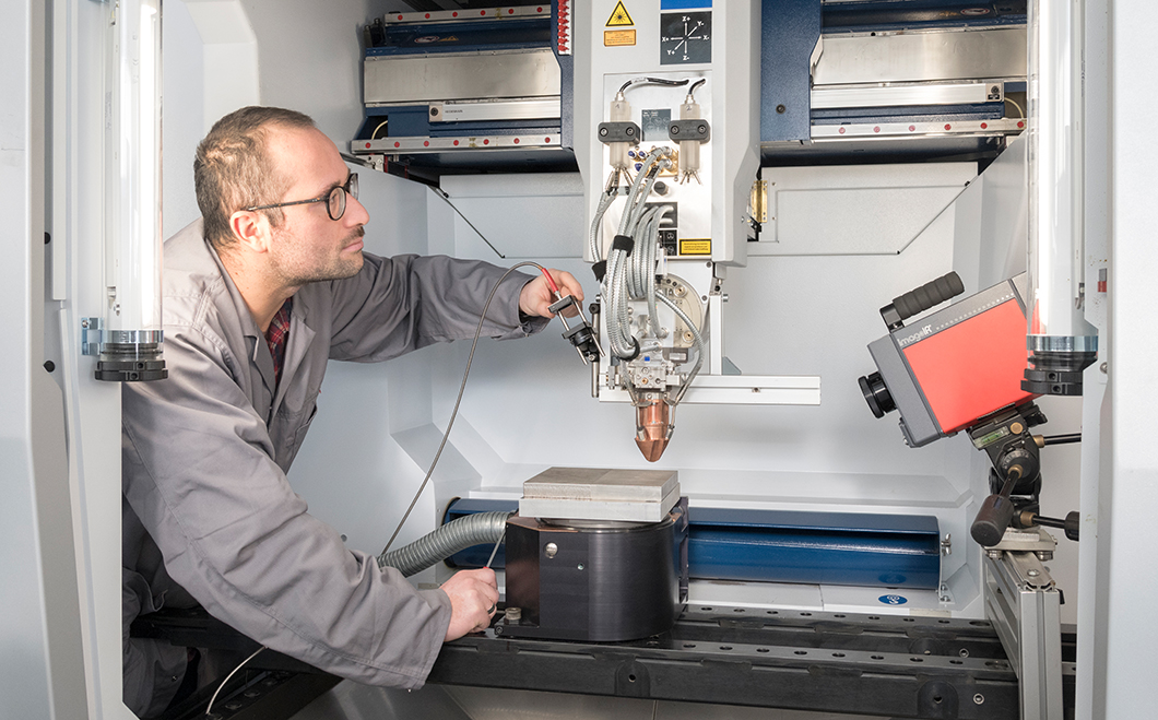 Mitarbeiter an einer Anlage zum Laser-Pulver-Auftragsschweißen Mitarbeiter an einer Anlage zum Laser-Pulver-Auftragsschweißen