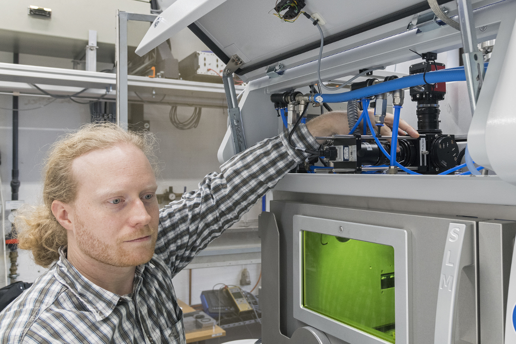 Dr Simon Altenburg adjusts the camera aperture on a laser beam melting device used for optical tomography. Dr Simon Altenburg adjusts the camera aperture on a laser beam melting device used for optical tomography.