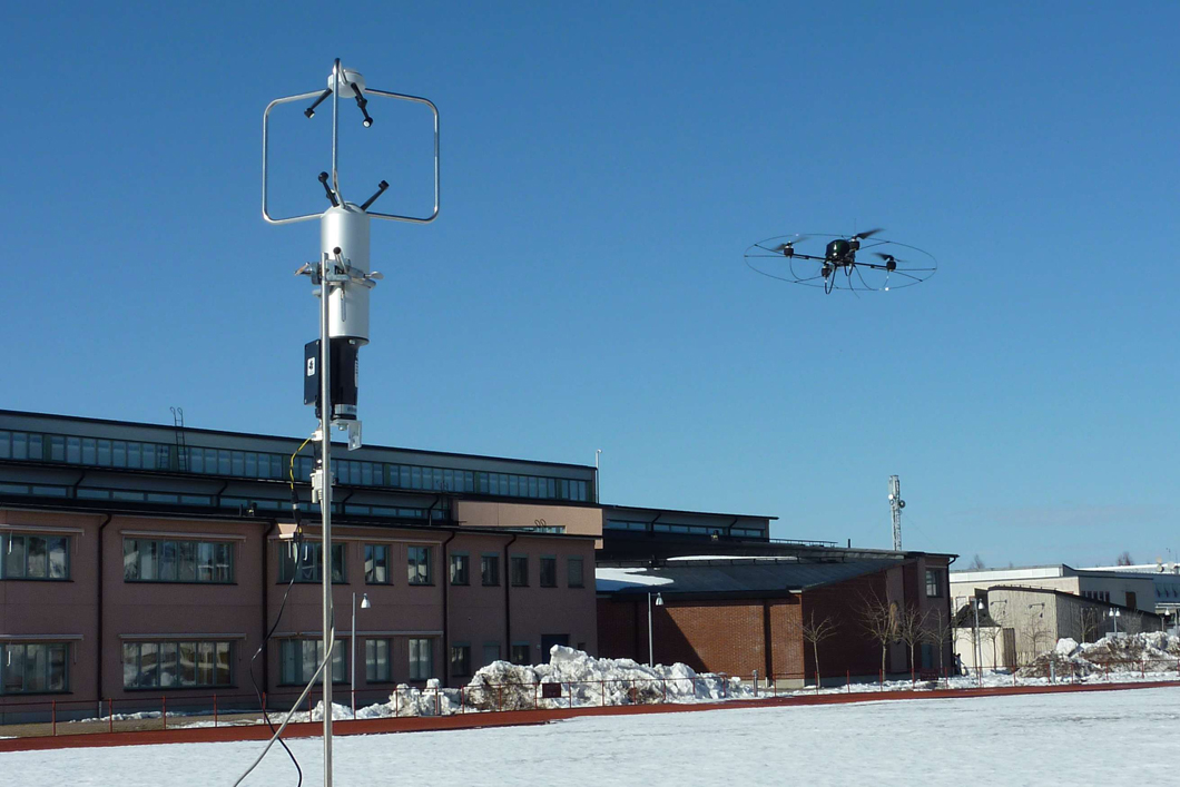 Micro-UAS and stationary 3D ultrasonic anemometer during open field validation of the in-situ meas-urement method for the determination of the local wind vector. 