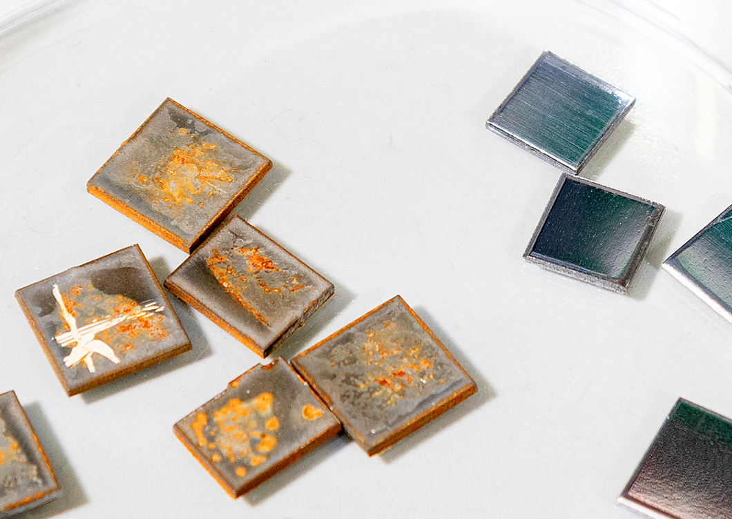 Metal samples were exposed to a medium containing microbes. The samples exposed to the medium show clear traces of corrosion. Metal samples were exposed to a medium containing microbes. The samples exposed to the medium show clear traces of corrosion.