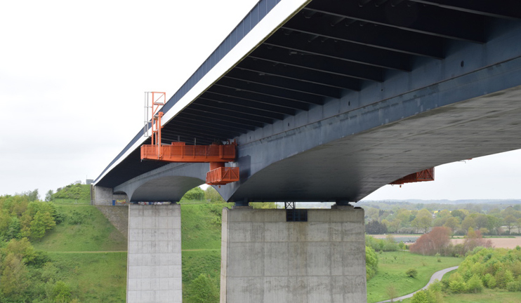 A concrete bridge with a maintenance platform installed below. A concrete bridge with a maintenance platform installed below.