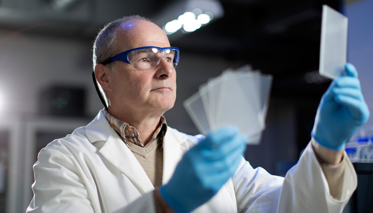 A BAM employee holds discs of polyurethane in his hand.  