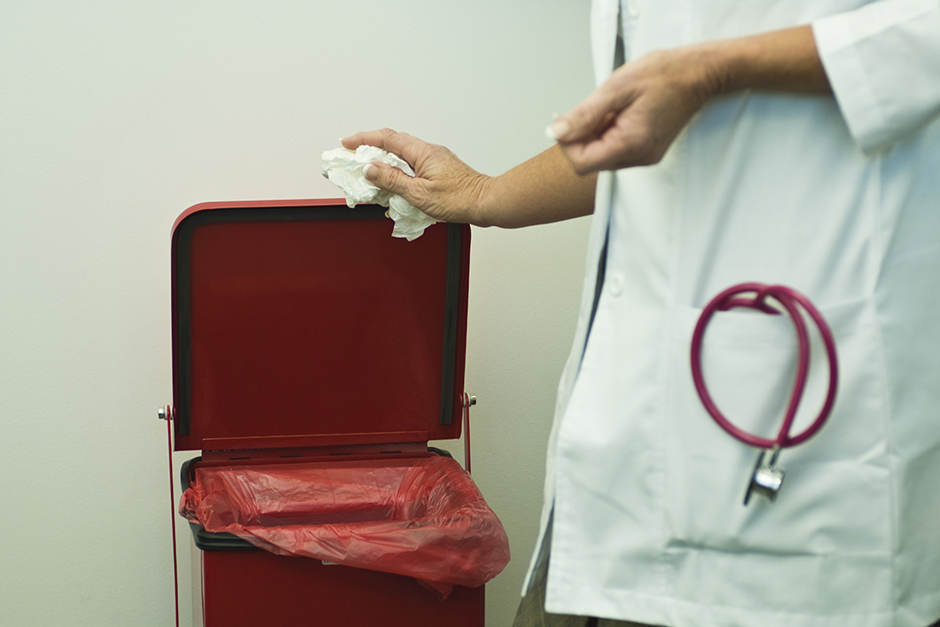 Discarding waste in medical waste bin Discarding waste in medical waste bin
